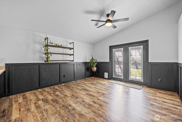 8308 Langara Dr, Pasco, WA 99301 - unfurnished room featuring lofted ceiling, wood finished floors, a wainscoted wall, french doors, and ceiling fan