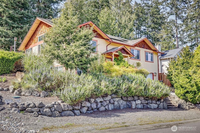 4243 Holcomb St, Port Townsend, WA 98368 - view of front facade featuring roof mounted solar panels and a garage