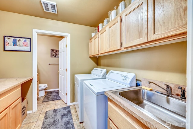 4243 Holcomb St, Port Townsend, WA 98368 - washroom featuring washer and dryer, cabinet space, and light tile patterned floors