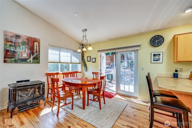 4243 Holcomb St, Port Townsend, WA 98368 - dining room featuring plenty of natural light, light wood finished floors, a wood stove, vaulted ceiling, and recessed lighting