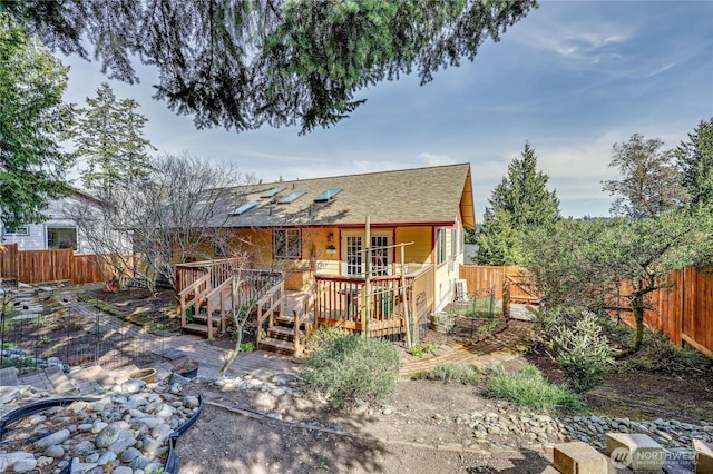 4243 Holcomb St, Port Townsend, WA 98368 - back of property with a wooden deck, a fenced backyard, and a shingled roof