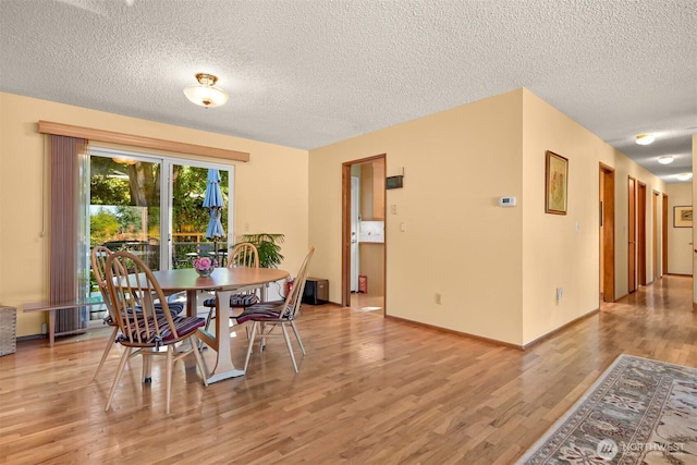 507 Lyla Ln, Bellingham, WA 98225 - dining space with a textured ceiling and light wood-style flooring