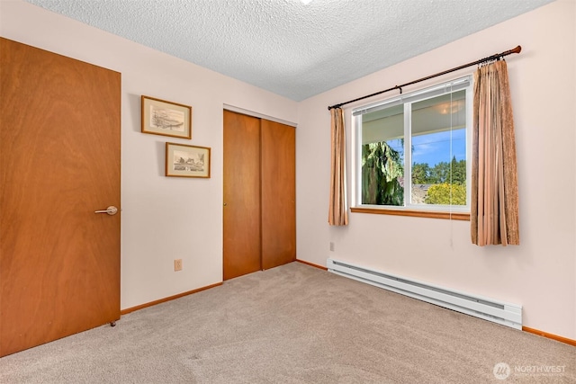 507 Lyla Ln, Bellingham, WA 98225 - unfurnished bedroom with a baseboard radiator, carpet, a textured ceiling, and a closet