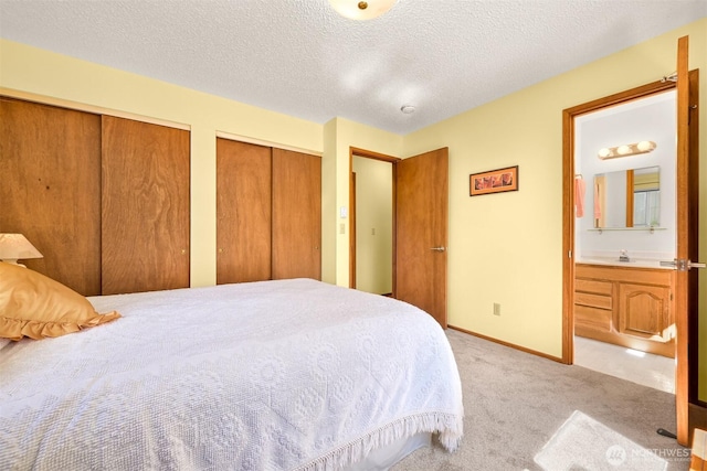 507 Lyla Ln, Bellingham, WA 98225 - bedroom featuring two closets, light colored carpet, ensuite bath, and a textured ceiling