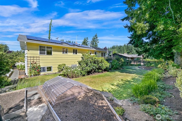 507 Lyla Ln, Bellingham, WA 98225 - rear view of house with solar panels and a vegetable garden