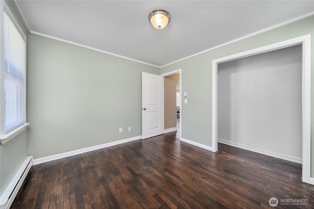 10812 2nd Ave S, Seattle, WA 98168 - unfurnished bedroom with baseboard heating, crown molding, and wood finished floors