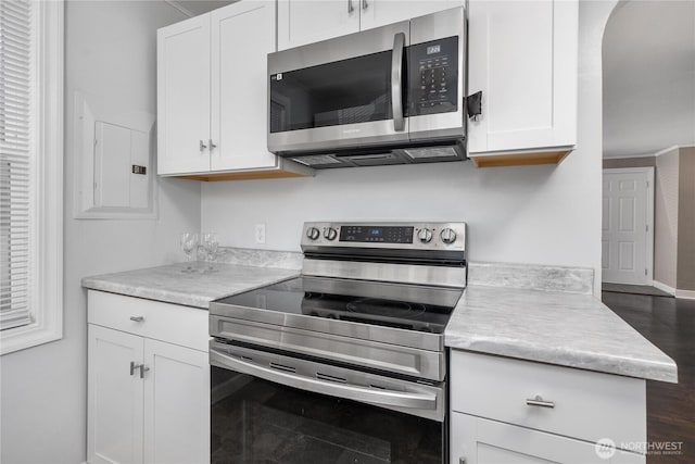 10812 2nd Ave S, Seattle, WA 98168 - kitchen with appliances with stainless steel finishes, white cabinetry, and light countertops