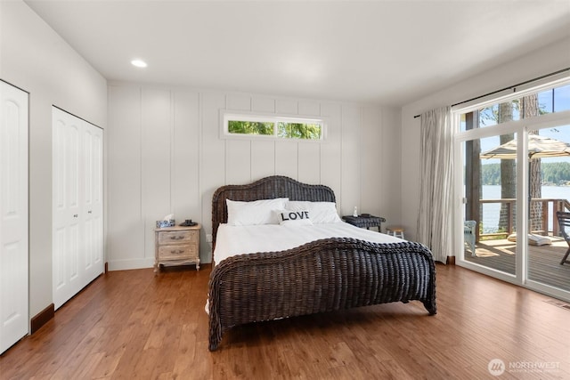 1321 E Mason Lake Dr E, Grapeview, WA 98546 - bedroom featuring access to outside, wood finished floors, and multiple windows