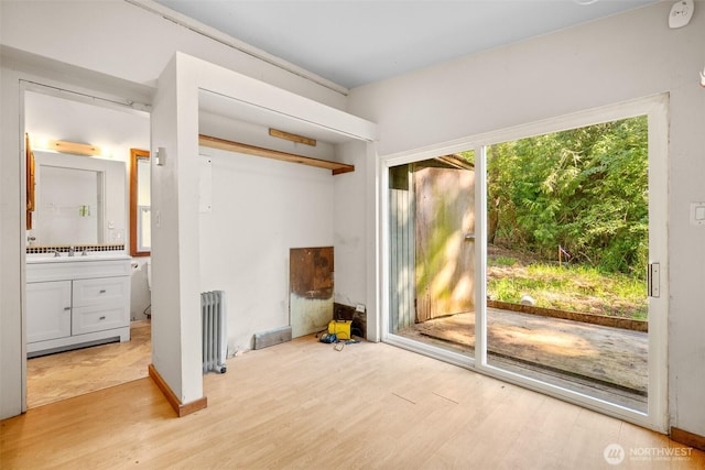 9330 Odell St, Blaine, WA 98230 - unfurnished bedroom featuring radiator heating unit, light wood-style flooring, access to exterior, connected bathroom, and a closet
