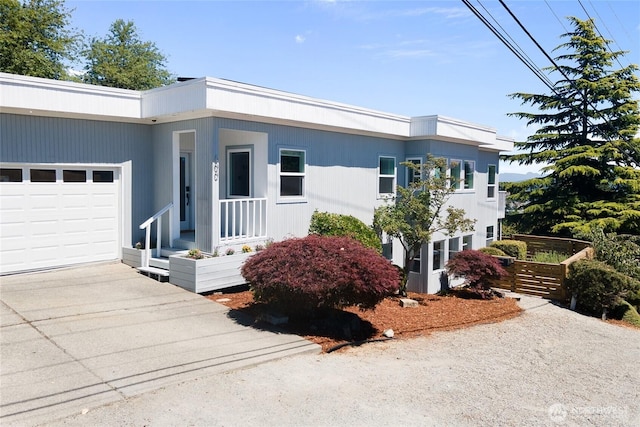 600 SW Cloverdale St, Seattle, WA 98106 - view of front of property with a garage and concrete driveway