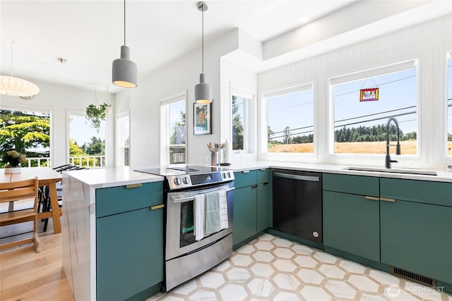 600 SW Cloverdale St, Seattle, WA 98106 - kitchen with stainless steel range with electric stovetop, dishwasher, green cabinetry, light countertops, and a peninsula