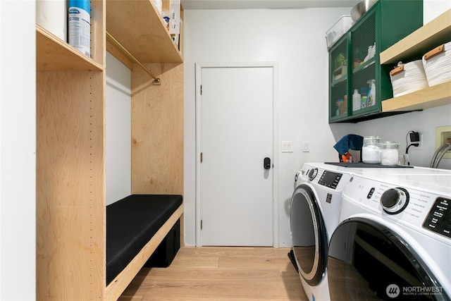 600 SW Cloverdale St, Seattle, WA 98106 - laundry room with washer and dryer and light wood-style floors
