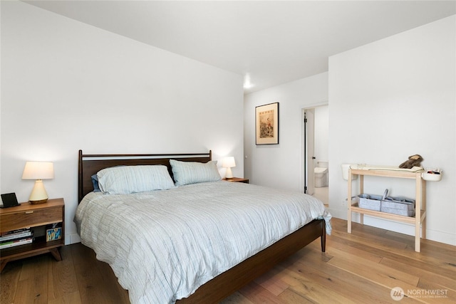 600 SW Cloverdale St, Seattle, WA 98106 - bedroom with wood-type flooring and ensuite bath