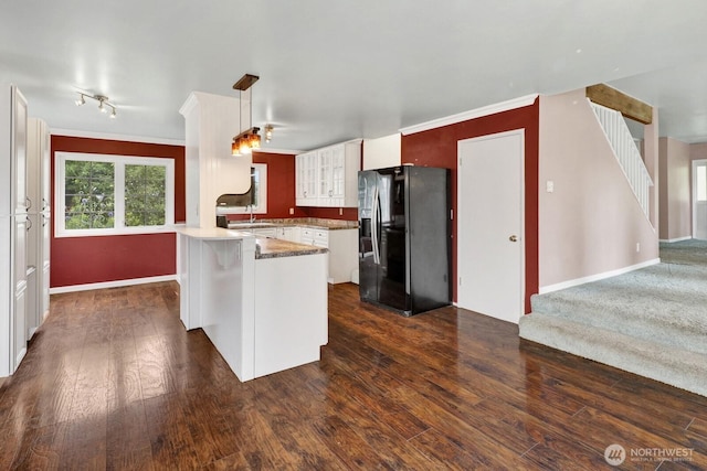 8597 Harborview Rd, Blaine, WA 98230 - kitchen with black fridge with ice dispenser, a peninsula, dark wood-type flooring, light countertops, and hanging light fixtures