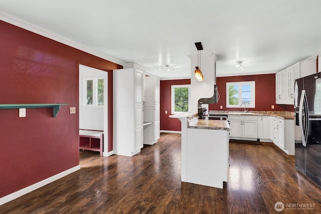 8597 Harborview Rd, Blaine, WA 98230 - kitchen with black refrigerator with ice dispenser, a peninsula, white cabinetry, dark wood-style floors, and ornamental molding