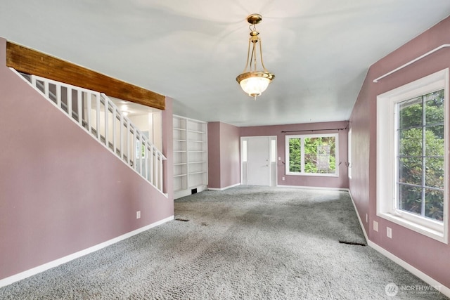 8597 Harborview Rd, Blaine, WA 98230 - unfurnished living room featuring stairs, carpet flooring, and built in features