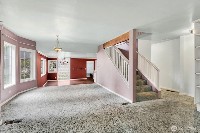 8597 Harborview Rd, Blaine, WA 98230 - unfurnished living room featuring carpet flooring, a chandelier, and stairs