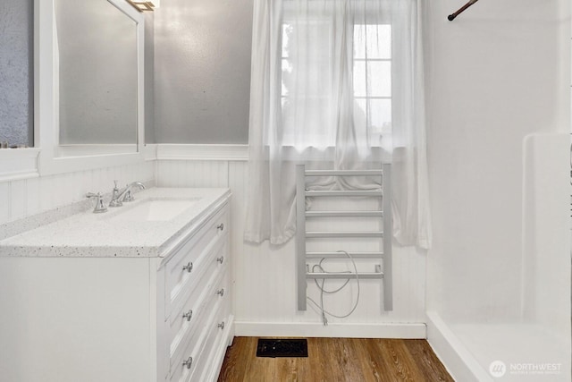8597 Harborview Rd, Blaine, WA 98230 - full bathroom with vanity, wood finished floors, wainscoting, and a shower
