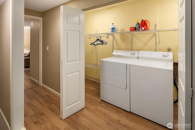 12810 NE 32nd Pl, Bellevue, WA 98005 - laundry area featuring washing machine and dryer and light wood-style flooring