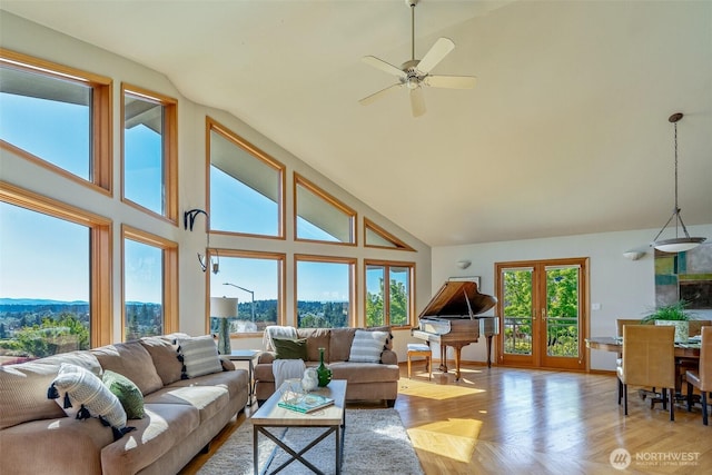 8705 Fenwick Loop SE, Olympia, WA 98513 - living area with high vaulted ceiling, wood finished floors, ceiling fan, and a mountain view