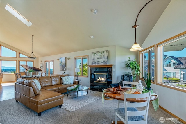 8705 Fenwick Loop SE, Olympia, WA 98513 - living area featuring healthy amount of natural light, carpet floors, high vaulted ceiling, a premium fireplace, and a skylight