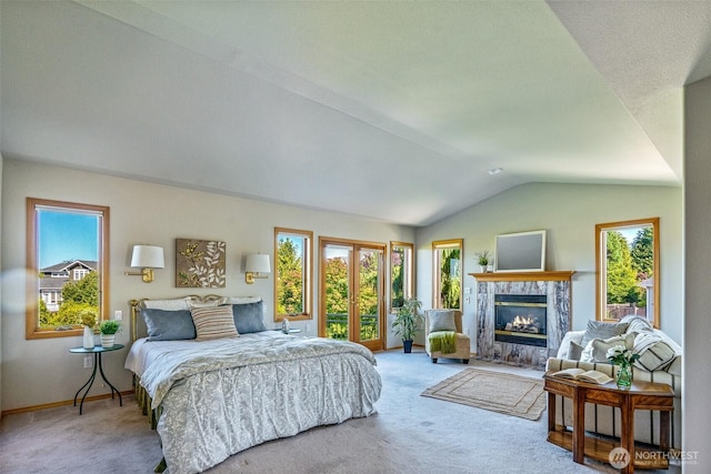 8705 Fenwick Loop SE, Olympia, WA 98513 - carpeted bedroom with vaulted ceiling, multiple windows, and a tile fireplace