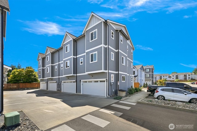 5690 Sunstone Pl Unit 101, Ferndale, WA 98248 - view of property exterior with a residential view, an attached garage, board and batten siding, and driveway