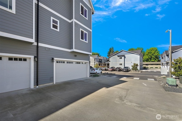 5690 Sunstone Pl Unit 101, Ferndale, WA 98248 - view of home's exterior featuring a garage, a residential view, and driveway