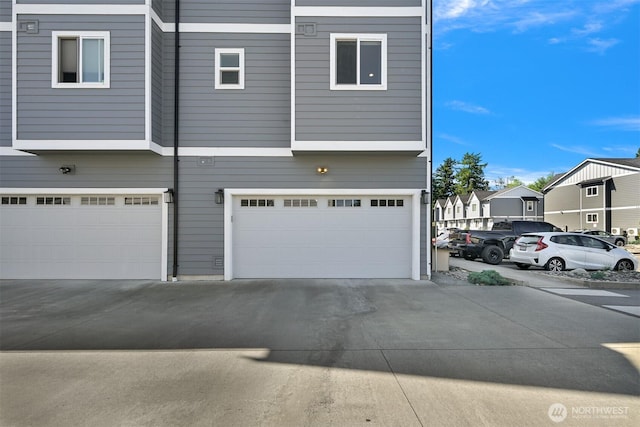 5690 Sunstone Pl Unit 101, Ferndale, WA 98248 - view of side of home with a garage, a residential view, and driveway