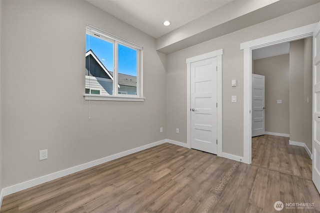 5690 Sunstone Pl Unit 101, Ferndale, WA 98248 - unfurnished bedroom with wood finished floors and recessed lighting