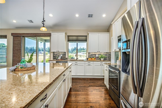 73 Sable Ct, Sequim, WA 98382 - kitchen featuring stainless steel appliances, recessed lighting, tasteful backsplash, dark wood-type flooring, and white cabinets