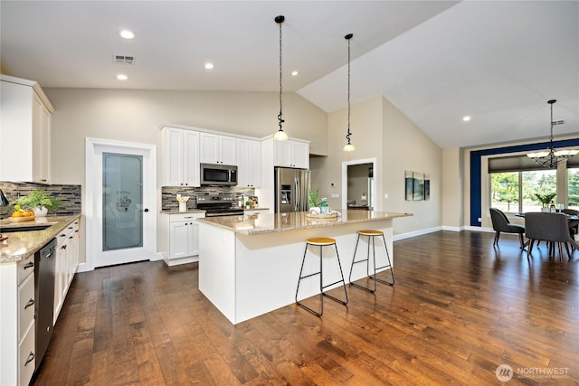 73 Sable Ct, Sequim, WA 98382 - kitchen featuring appliances with stainless steel finishes, a center island, decorative backsplash, white cabinetry, and high vaulted ceiling