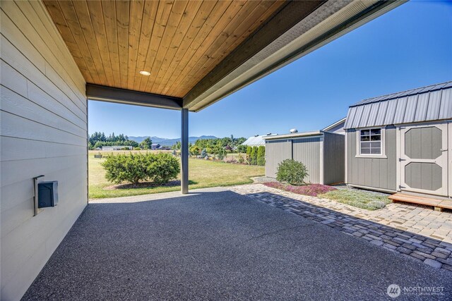 73 Sable Ct, Sequim, WA 98382 - view of patio / terrace with a storage shed and a mountain view