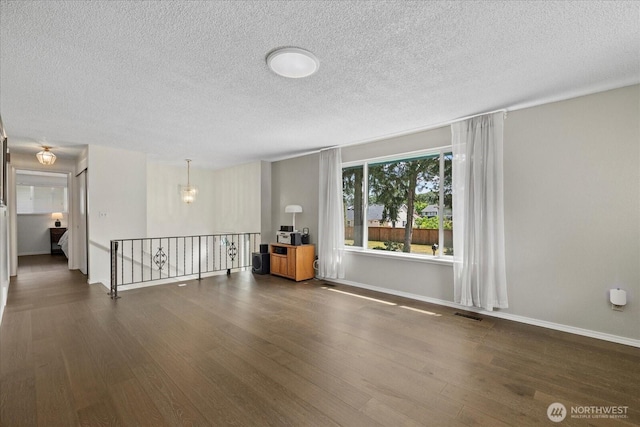 14416 4th Ave E, Tacoma, WA 98445 - spare room with wood finished floors and a textured ceiling