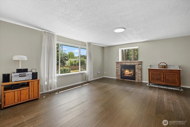 14416 4th Ave E, Tacoma, WA 98445 - living room with wood finished floors, a glass covered fireplace, and a textured ceiling