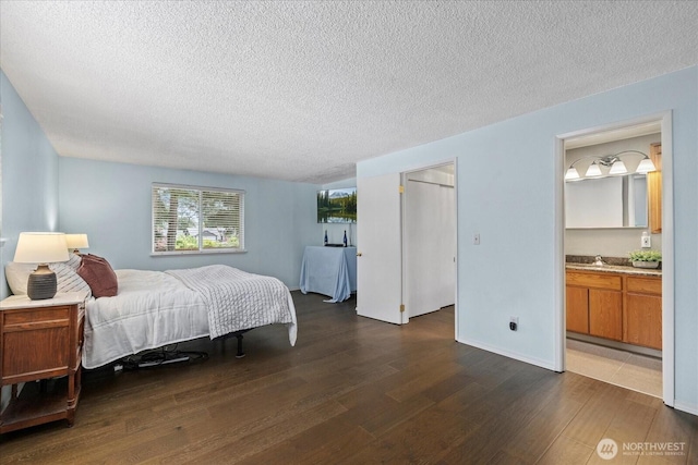14416 4th Ave E, Tacoma, WA 98445 - bedroom featuring a textured ceiling, wood finished floors, and ensuite bathroom