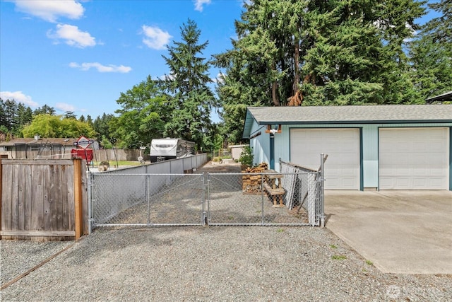 14416 4th Ave E, Tacoma, WA 98445 - detached garage featuring a gate and view of wooded area
