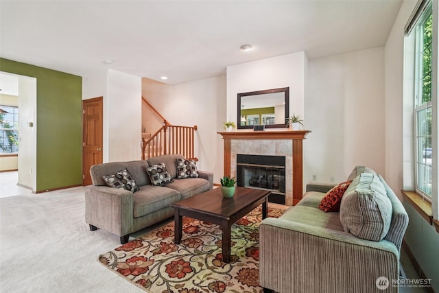 22727 NE 4th Pl Unit 117, Sammamish, WA 98074 - carpeted living area featuring a tiled fireplace, stairs, and recessed lighting