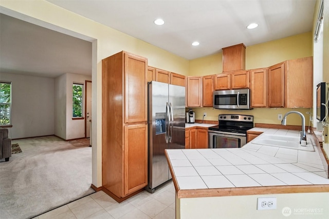 22727 NE 4th Pl Unit 117, Sammamish, WA 98074 - kitchen featuring stainless steel appliances, tile countertops, a peninsula, light carpet, and recessed lighting