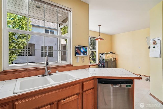 22727 NE 4th Pl Unit 117, Sammamish, WA 98074 - kitchen featuring dishwasher, brown cabinets, a peninsula, pendant lighting, and light tile patterned floors