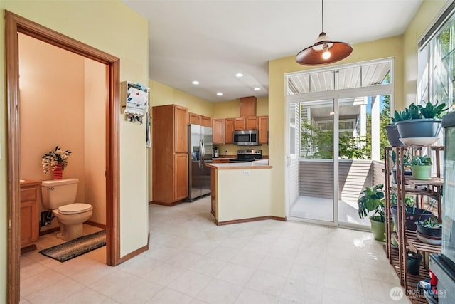 22727 NE 4th Pl Unit 117, Sammamish, WA 98074 - kitchen featuring stainless steel appliances, pendant lighting, light countertops, brown cabinetry, and a peninsula