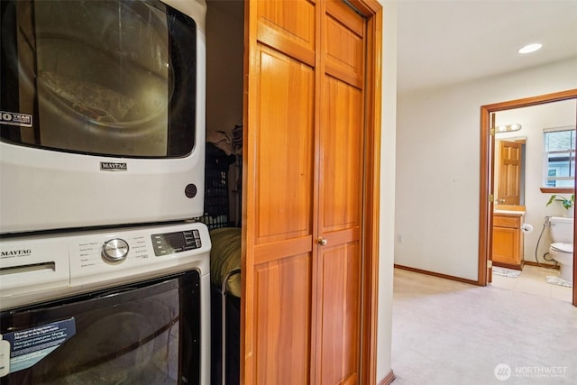 22727 NE 4th Pl Unit 117, Sammamish, WA 98074 - washroom featuring estacked washer and dryer and light colored carpet