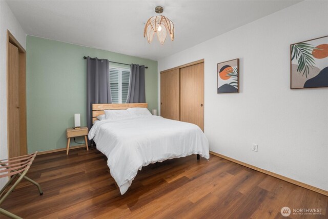 853 Ocean Shores Blvd NW Unit 4, Ocean Shores, WA 98569 - bedroom with a closet, wood finished floors, and a chandelier