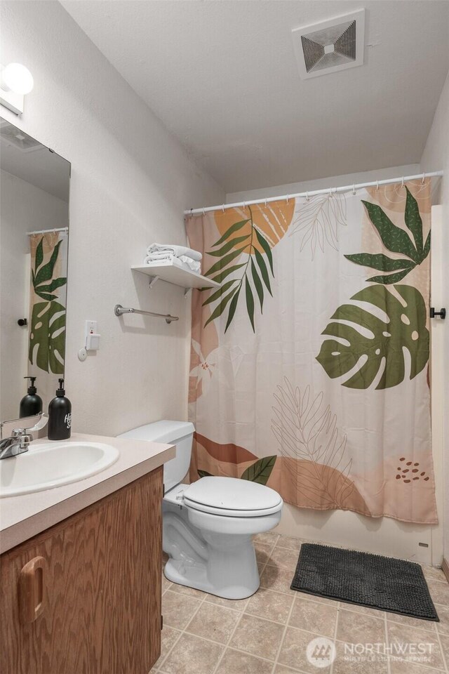 853 Ocean Shores Blvd NW Unit 4, Ocean Shores, WA 98569 - full bathroom featuring vanity, shower / bathtub combination with curtain, and tile patterned floors