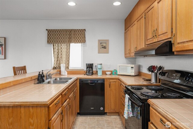 853 Ocean Shores Blvd NW Unit 4, Ocean Shores, WA 98569 - kitchen featuring black appliances, tile counters, under cabinet range hood, recessed lighting, and a peninsula