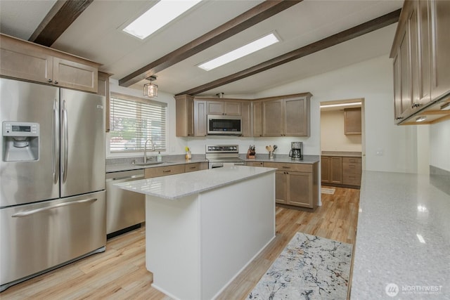 1411 Kimberly Ave Unit 50, Enumclaw, WA 98022 - kitchen featuring stainless steel appliances, a center island, light stone counters, and light wood finished floors