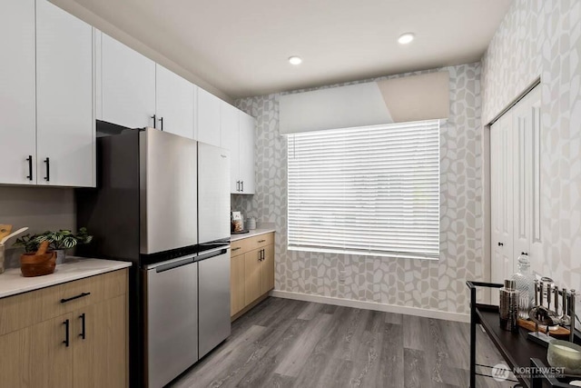 14707 87th Ave SE Unit V4, Snohomish, WA 98296 - kitchen with freestanding refrigerator, wallpapered walls, dark wood-type flooring, light countertops, and white cabinets