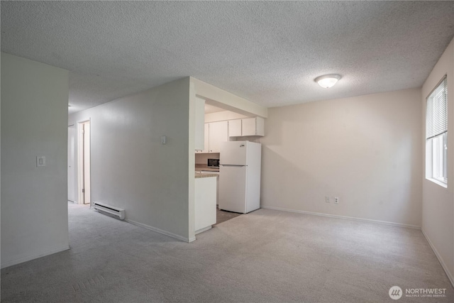 230 SW Clark St Unit C203, Issaquah, WA 98207 - unfurnished room featuring a baseboard heating unit, a textured ceiling, and light carpet
