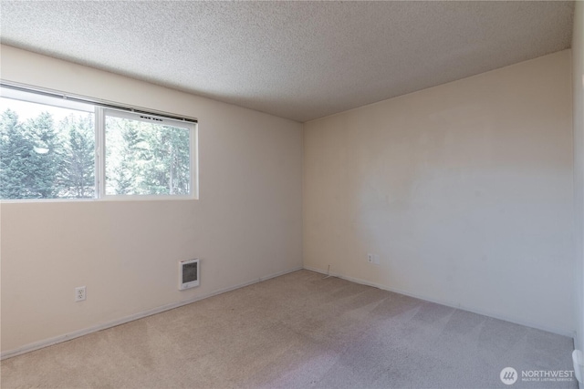 230 SW Clark St Unit C203, Issaquah, WA 98207 - unfurnished room featuring light colored carpet, heating unit, and a textured ceiling