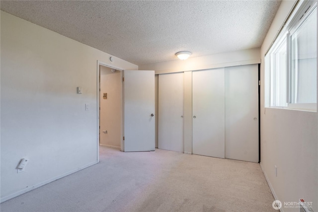 230 SW Clark St Unit C203, Issaquah, WA 98207 - unfurnished bedroom featuring carpet flooring, a textured ceiling, and a closet